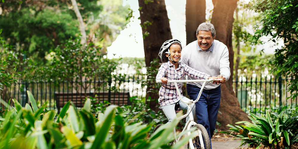 Grandpa and granddaughter riding bike